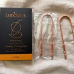 Two 100% pure copper tongue scrapers beside the open Lunology box