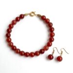 Natural carnelian necklace with polished beads and an ornate gold clasp