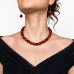 Natural carnelian necklace with polished beads and an ornate gold clasp