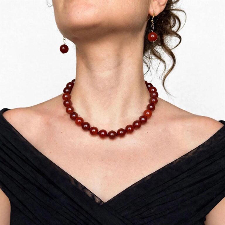 Natural carnelian necklace with polished beads and an ornate gold clasp