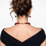 Natural carnelian necklace with polished beads and an ornate gold clasp